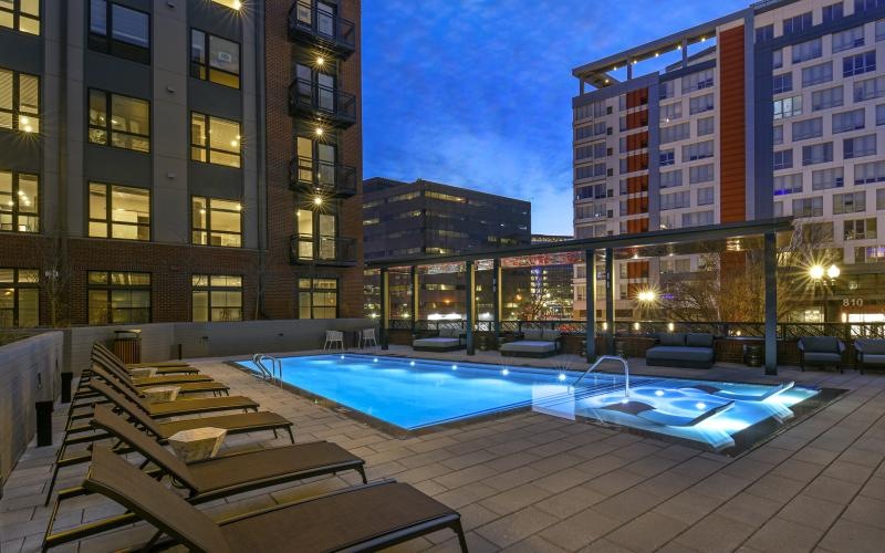 a swimming pool with lounge chairs
