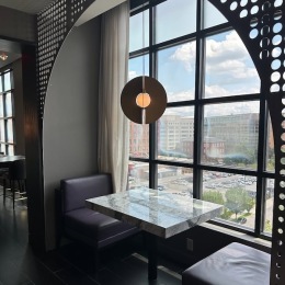 a booth with a table and a large window