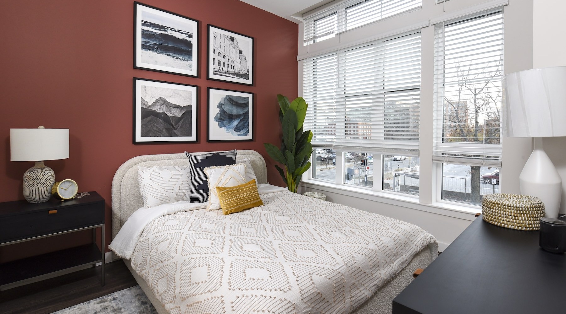 a bedroom with a bed and a red wall