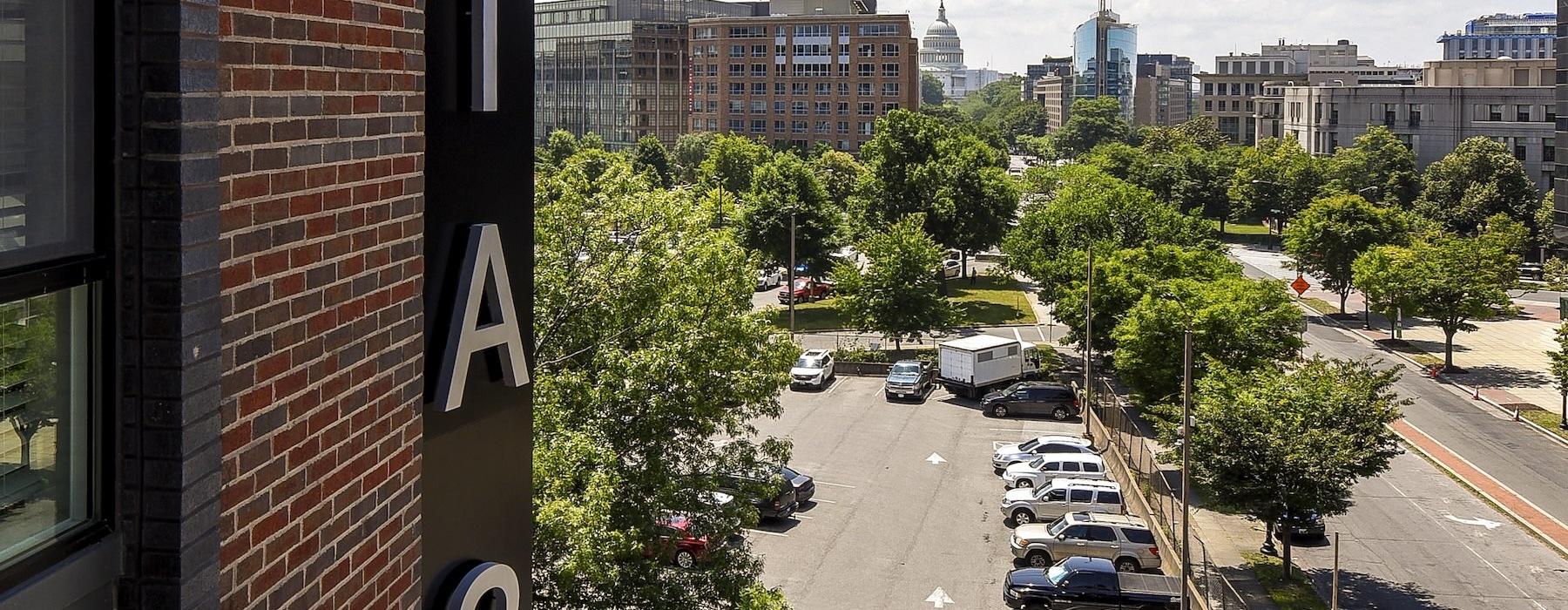 a view of a street and cars from a window of a building
