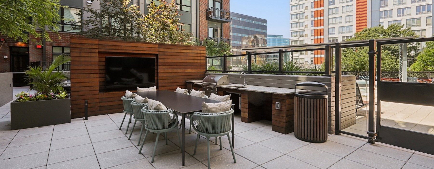a courtyard with a table, chairs and a tv