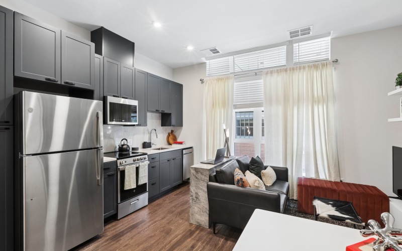 a kitchen and a living room with a couch