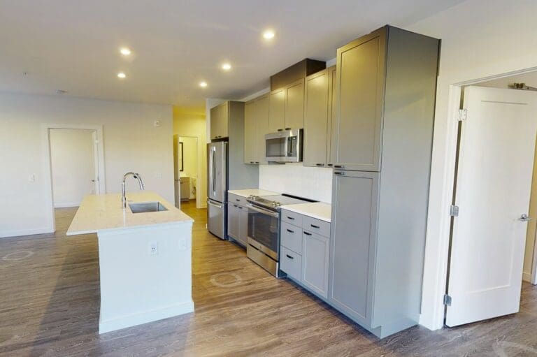Kitchen with an island and wood-style flooring at our modern apartments in Capitol Hill