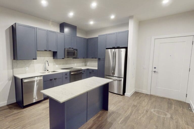 Luxury kitchen with an island and designer wood-style flooring at our apartments in Capitol Hill