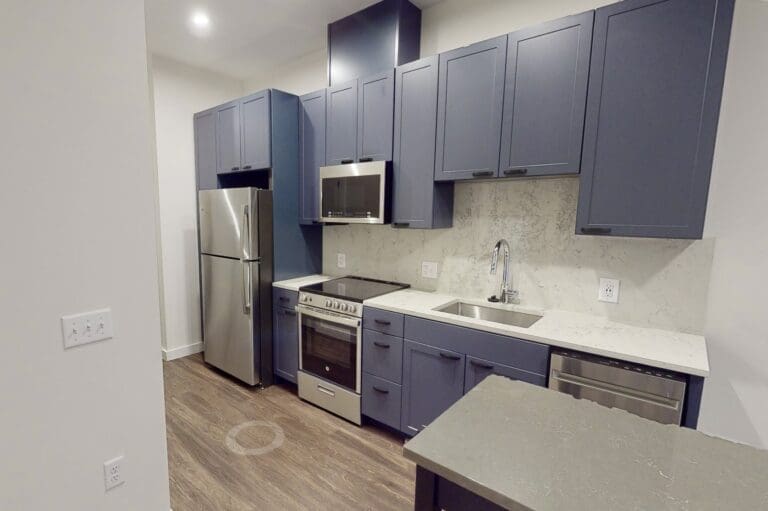 Kitchen with a designer backsplash and soft-close cabinets at our apartments in Capitol Hill